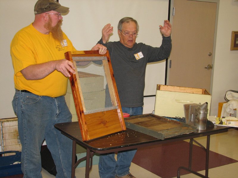 beecourse_day1 024.JPG - Allen holds a screened bottom board as Bill explains adding honey supers.